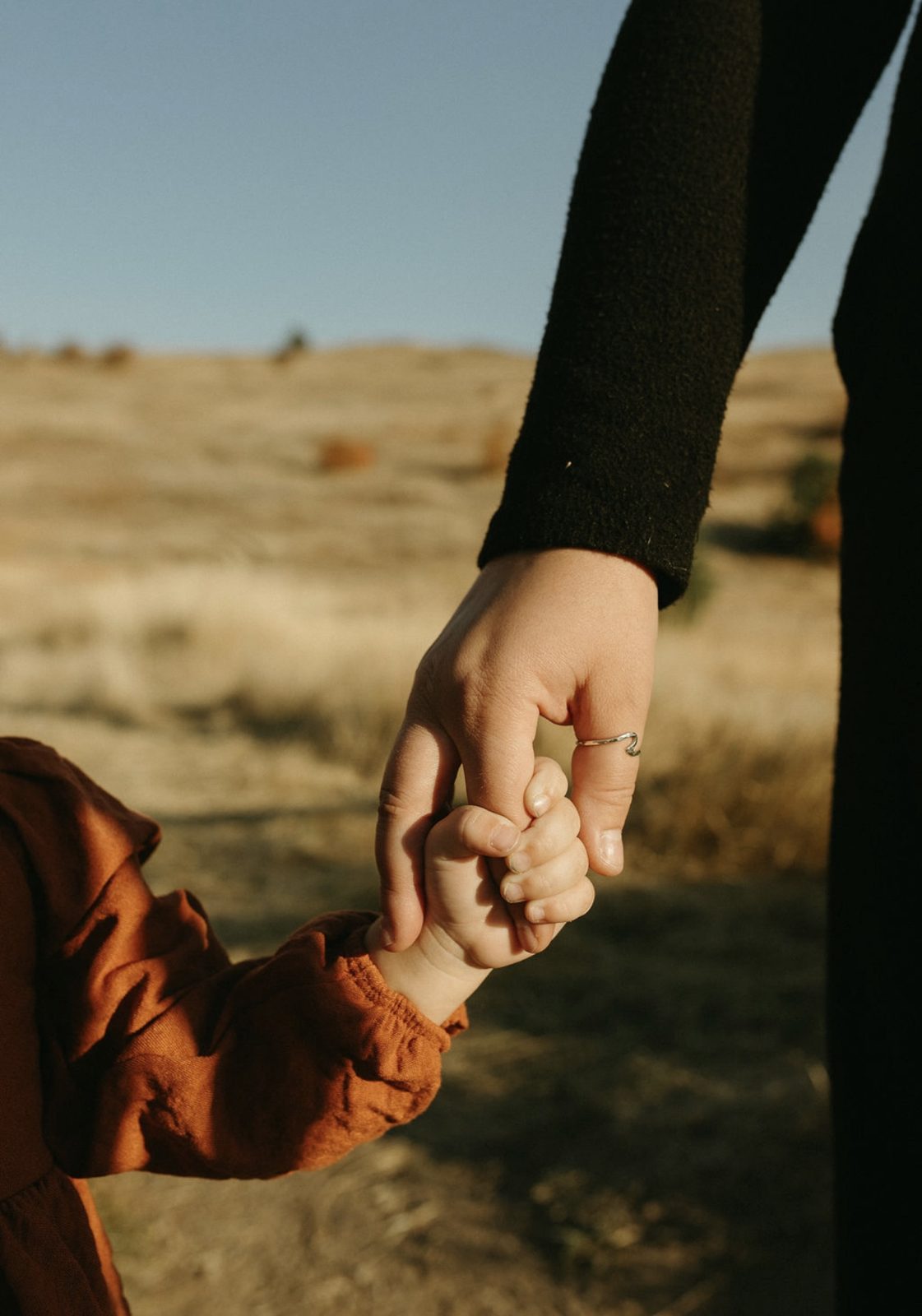 Emma McNiven holding hands with her child